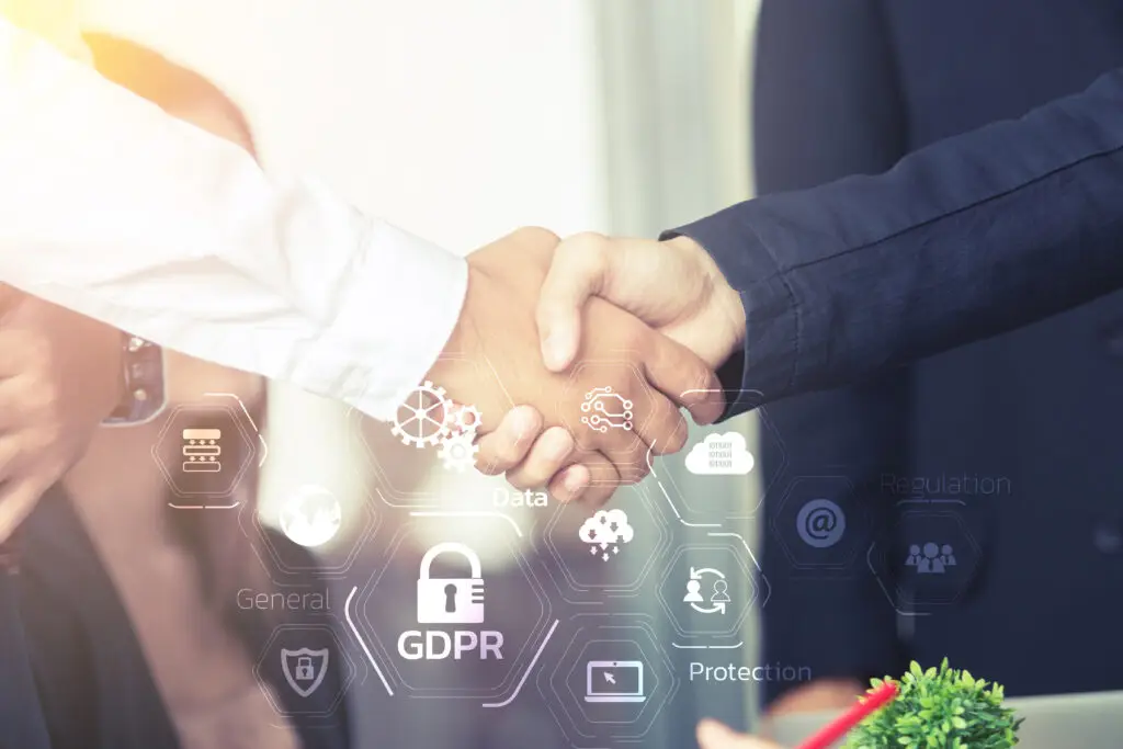 Two business professionals shaking hands, symbolizing secure AWS partnership and GDPR-compliant cloud consulting.